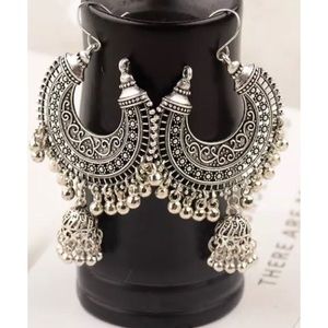 Ethnic dangling earrings in silver color